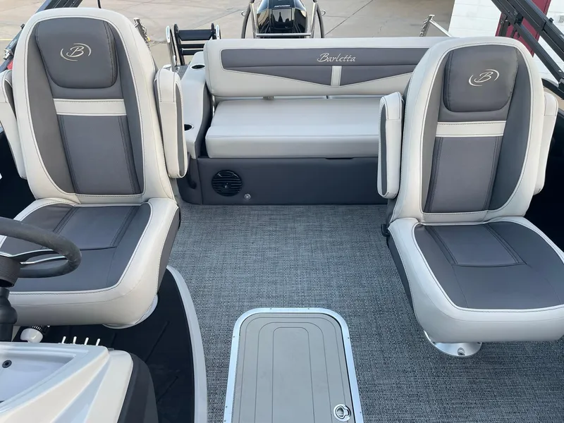 Slide: The Image of 2024 Barletta Cabrio 22UC boat interior with gray seating and carpeted flooring. - 27