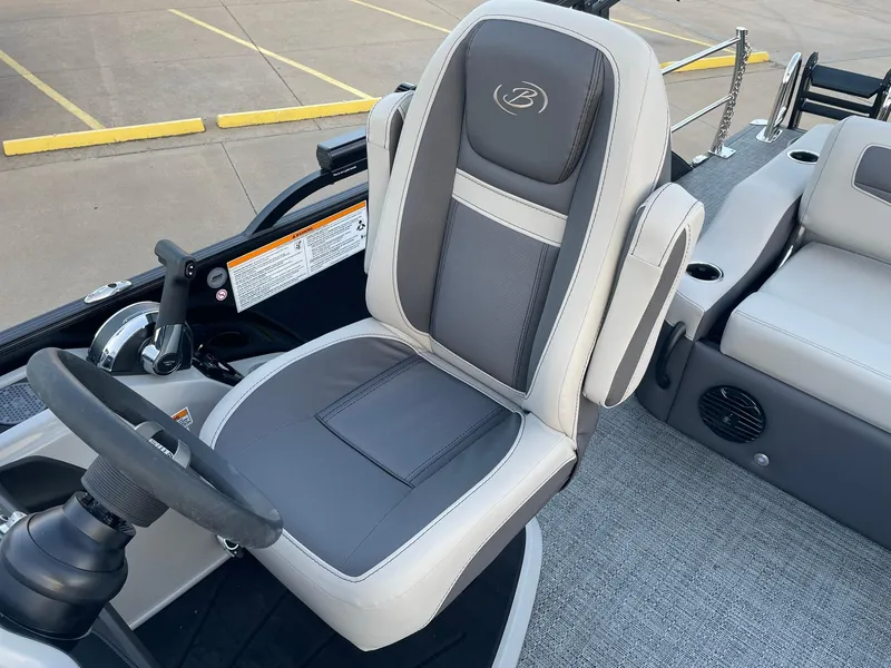 Slide: The Image of 2024 Barletta Cabrio 22UC boat interior with steering wheel and comfortable seating. - 29