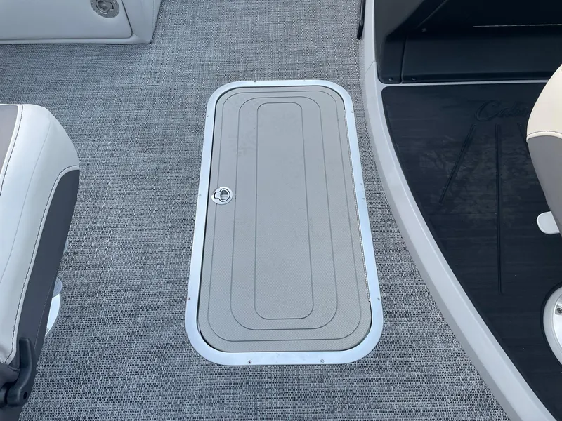 Slide: The Image of 2024 Barletta Cabrio 22UC boat floor with storage hatch and seating. - 37