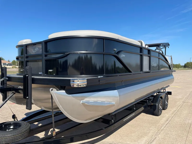 Slide: The Image of 2024 Barletta Cabrio 22UC pontoon boat on trailer, sleek black and silver design. - 4