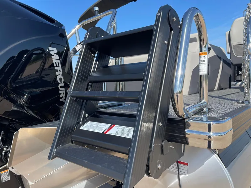 Slide: The Image of 2024 Barletta Cabrio 22UC boat ladder with Mercury engine in background. - 9
