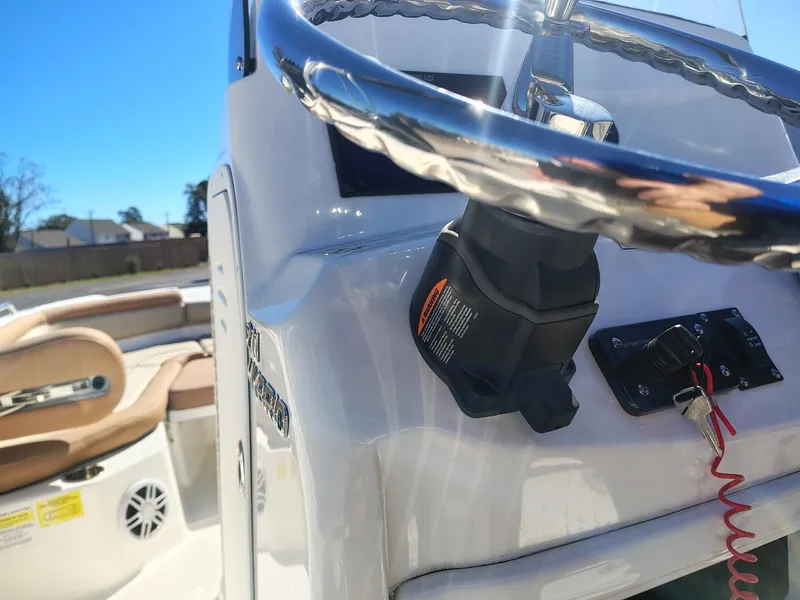 Slide: The Image of 2024 NauticStar 211 Hybrid boat steering console with controls and seating. - 12