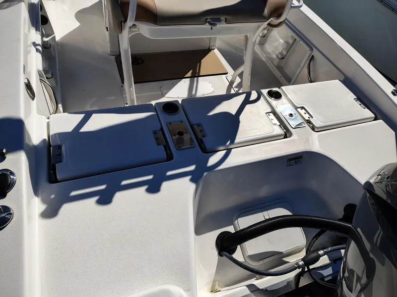 Slide: The Image of 2024 NauticStar 211 Hybrid boat interior with storage compartments and seating. - 15