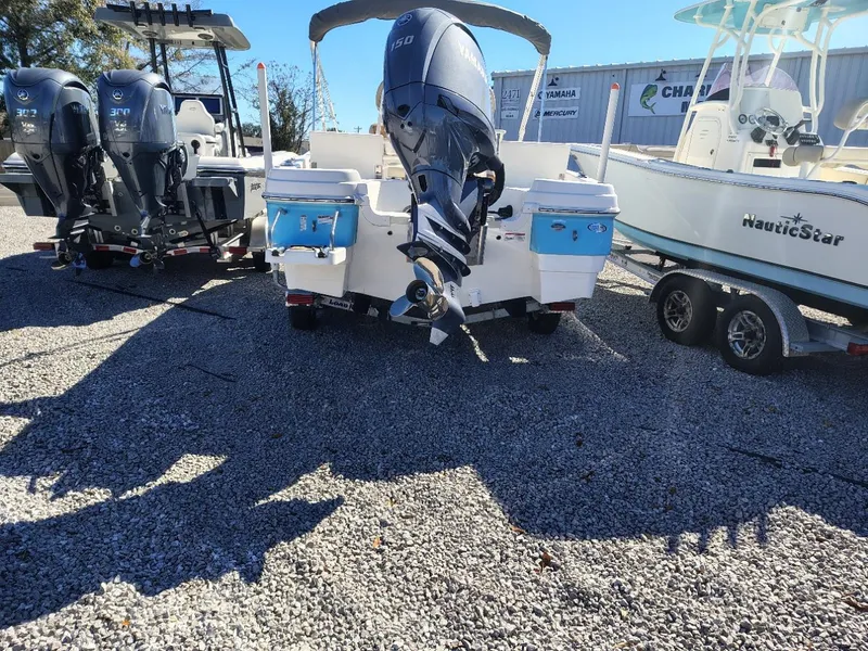 Slide: The Image of 2024 NauticStar 211 Hybrid boat on trailer, displayed outdoors. - 17