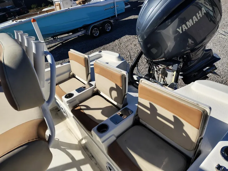 Slide: The Image of 2024 NauticStar 211 Hybrid boat interior with Yamaha engine, featuring comfortable seating and cup holders. - 3