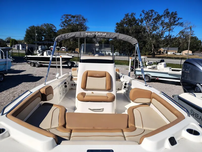 Slide: The Image of 2024 NauticStar 211 Hybrid boat with tan seating, outdoor display. - 4