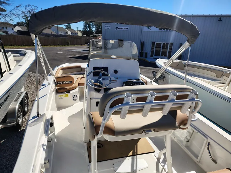 Slide: The Image of 2024 NauticStar 211 Hybrid boat interior with steering console and seating. - 6
