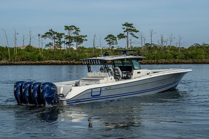 Slide: The Image of HCB 53 boat, 2017 model, cruising on calm water with four outboard engines. - 0