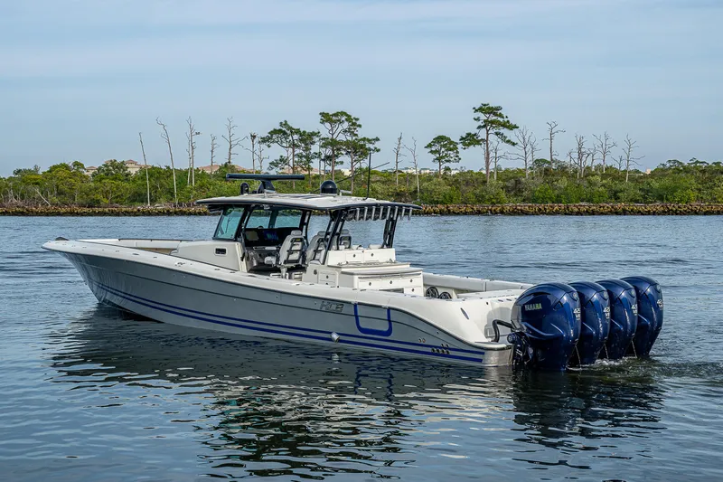 Slide: The Image of HCB 53 boat, 2017 model, cruising on calm water with four outboard engines. - 1