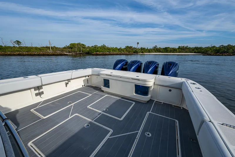 Slide: The Image of 2017 HCB 53 boat with spacious deck and four powerful engines on a calm waterway. - 13