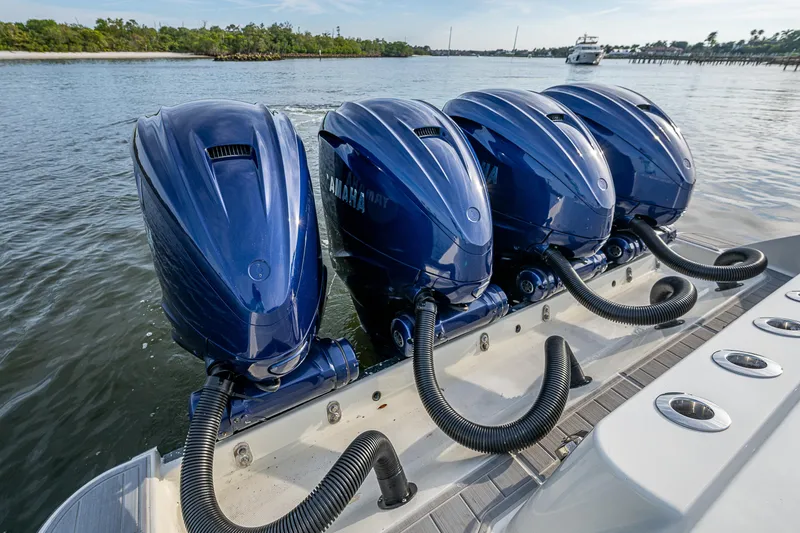 Slide: The Image of Four blue Yamaha outboard motors on a 2017 HCB 53 boat in water. - 16