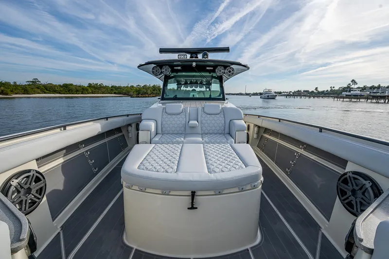 Slide: The Image of 2017 HCB 53 boat interior with luxurious seating on a calm waterway. - 22