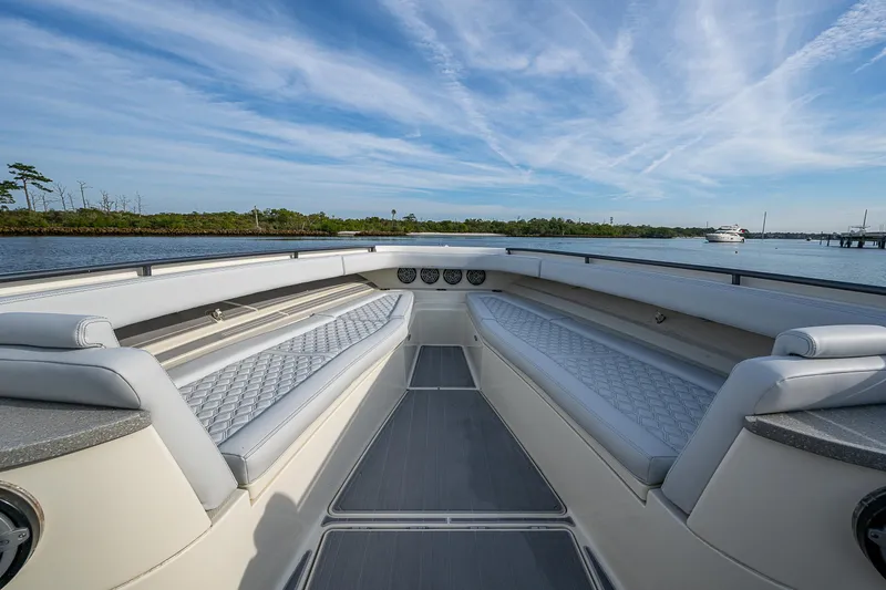 Slide: The Image of 2017 HCB 53 boat interior with cushioned seating, open water view, and clear sky. - 26