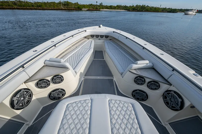 Slide: The Image of Luxurious 2017 HCB 53 boat interior with cushioned seating and speaker system on calm water. - 27