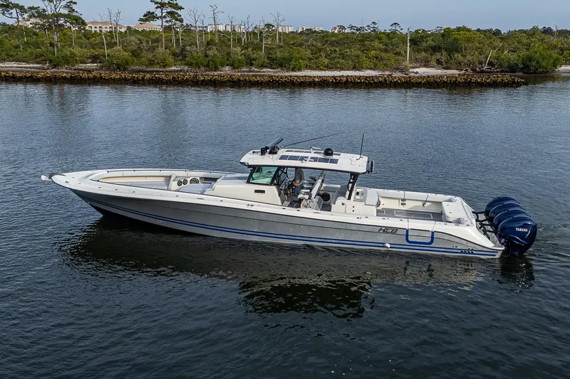 Slide: The Image of 2017 HCB 53 boat on calm water, featuring sleek design and powerful engines. - 3
