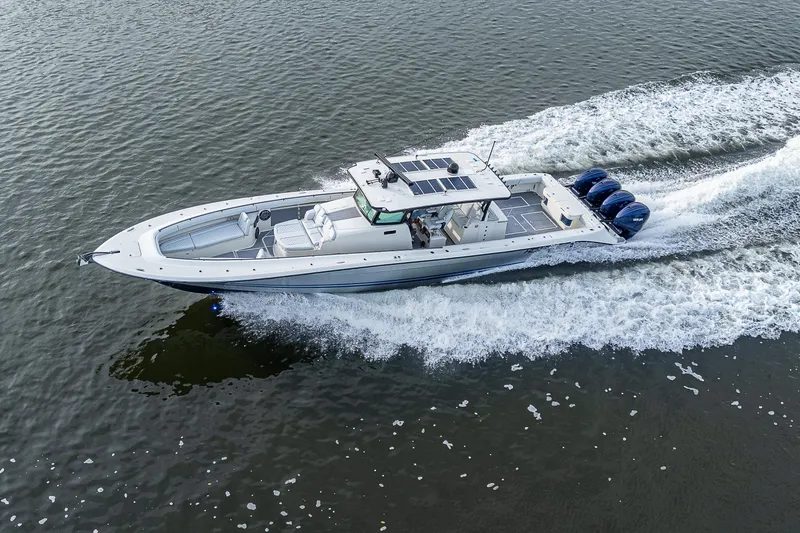 Slide: The Image of 2017 HCB 53 boat cruising on water with four outboard engines. - 31