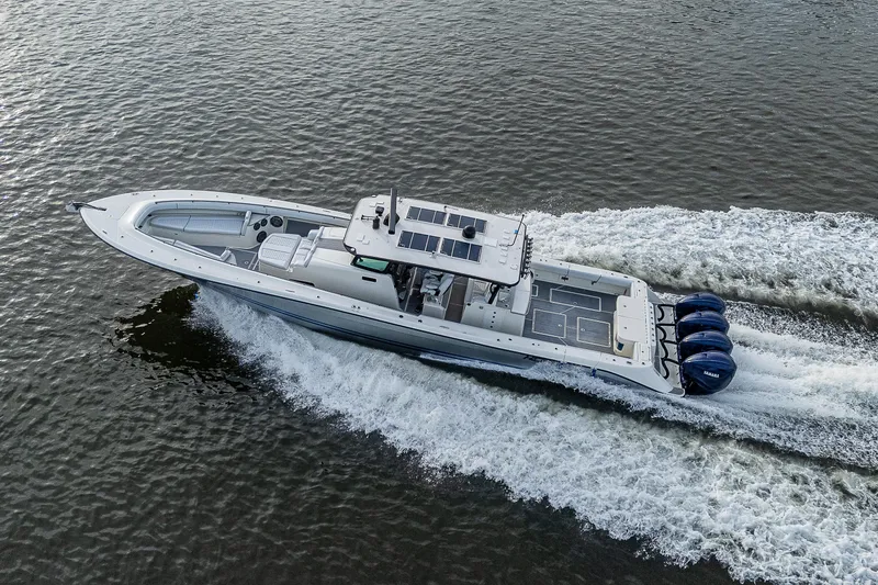 Slide: The Image of HCB 53 boat from 2017 cruising on water with four engines. - 32