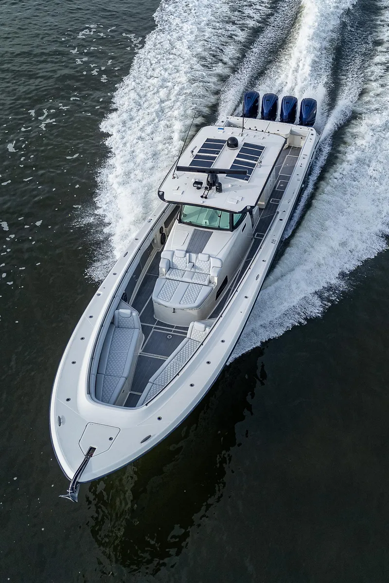 Slide: The Image of HCB 53 2017 boat cruising on water, featuring four powerful outboard engines. - 34