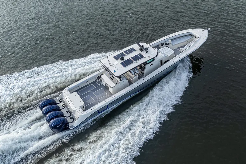 Slide: The Image of HCB 53 boat from 2017 cruising on water with four engines. - 35