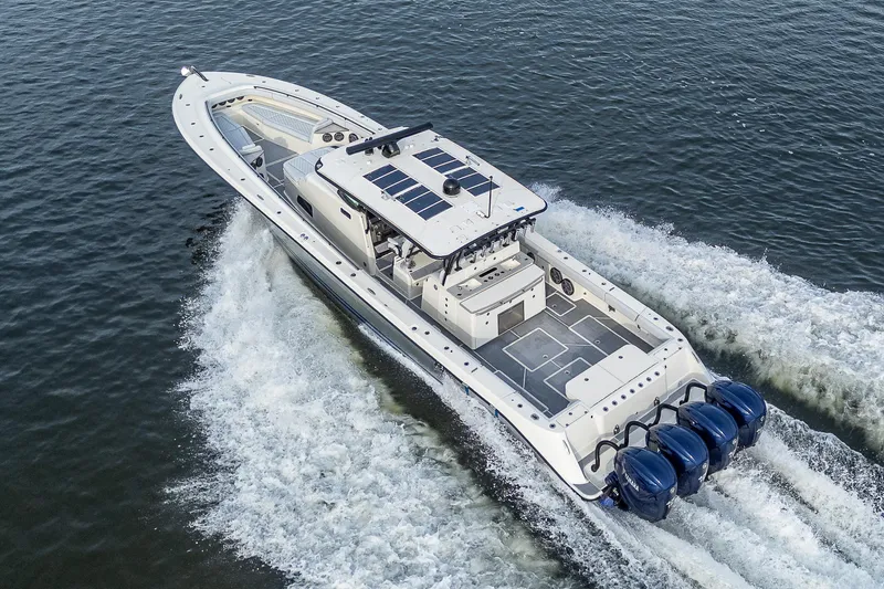 Slide: The Image of 2017 HCB 53 boat cruising on water with multiple outboard engines. - 37