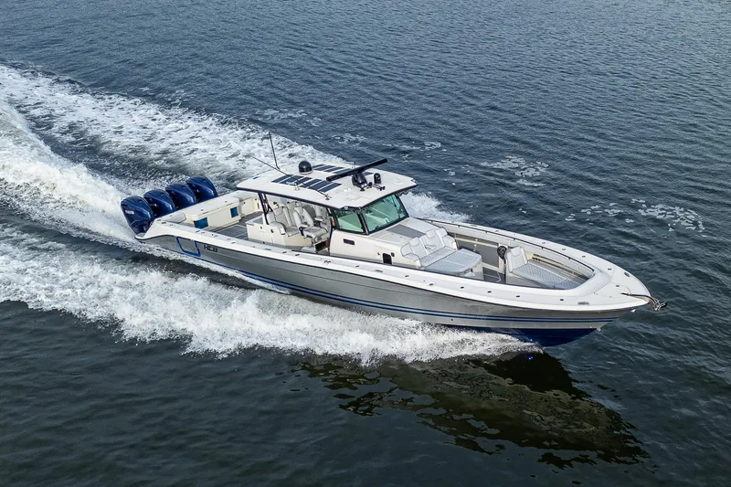 Slide: The Image of 2017 HCB 53 boat cruising on open water with four powerful engines. - 43