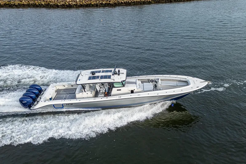 Slide: The Image of 2017 HCB 53 boat cruising on water with multiple outboard engines. - 44