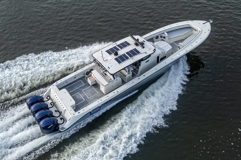 Slide: The Image of 2017 HCB 53 boat cruising on water with four powerful engines. - 46