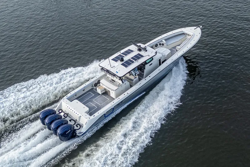 Slide: The Image of 2017 HCB 53 boat cruising on water with four powerful outboard engines. - 47