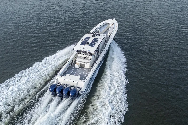 Slide: The Image of 2017 HCB 53 boat cruising on open water, aerial view. - 48