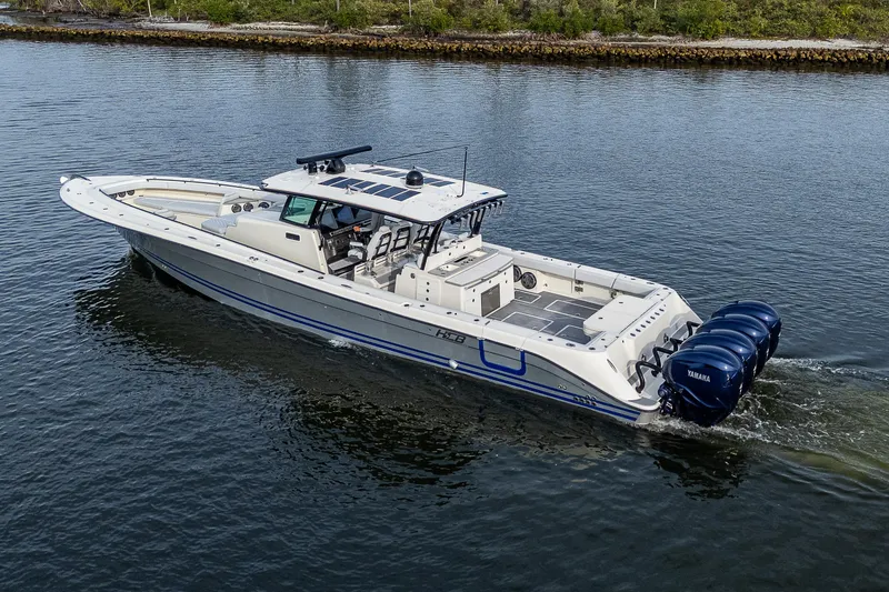 Slide: The Image of 2017 HCB 53 boat cruising on water with multiple outboard engines. - 49