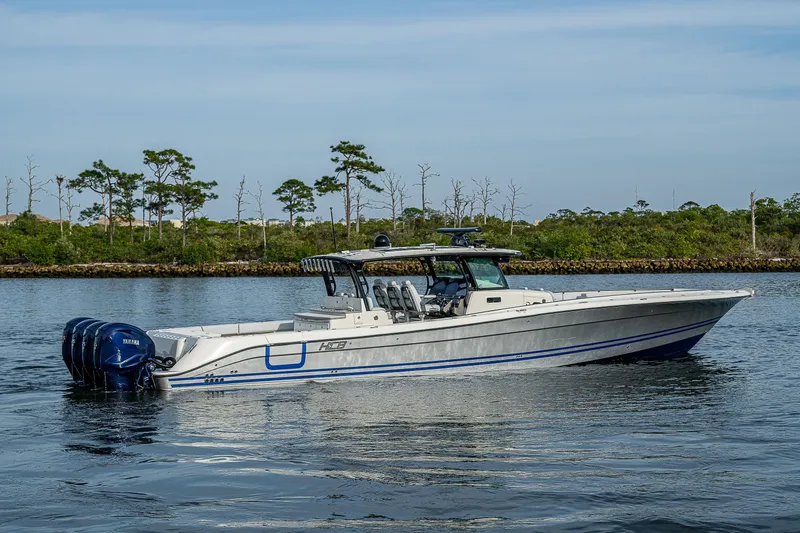 Slide: The Image of 2017 HCB 53 boat on calm water with trees in the background. - 6