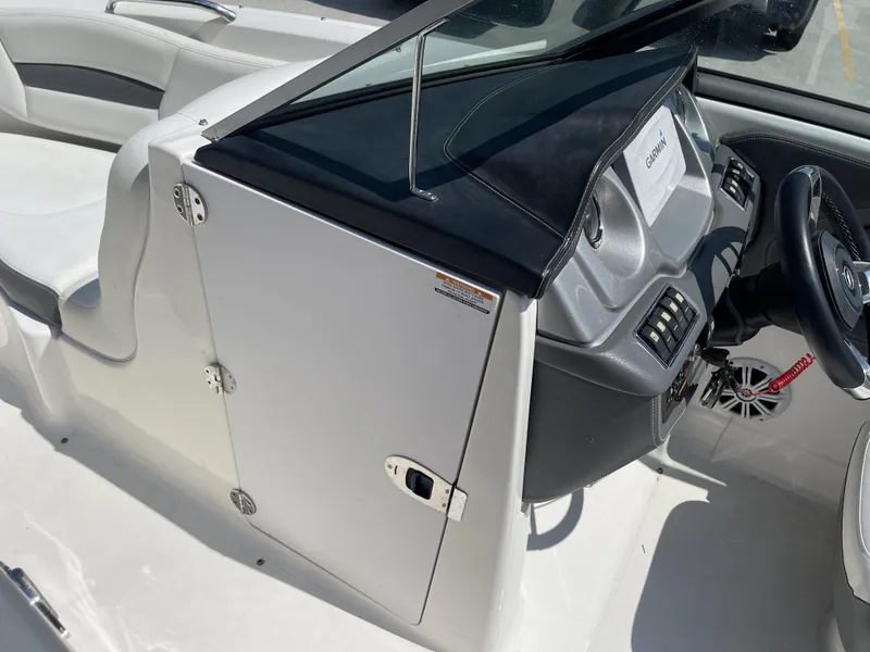 Slide: The Image of 2014 Chaparral Sunesta 224 boat dashboard with Garmin navigation system and steering wheel. - 10