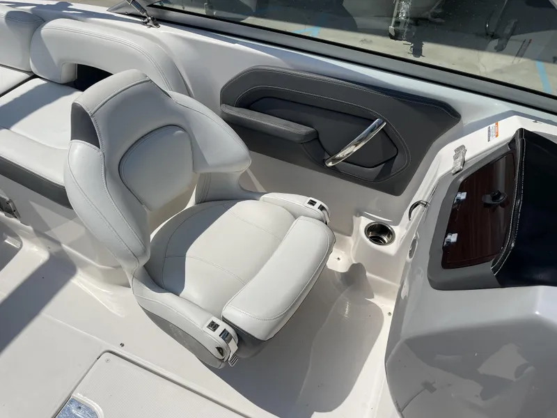 Slide: The Image of 2014 Chaparral Sunesta 224 boat interior with steering wheel and seating area. - 12