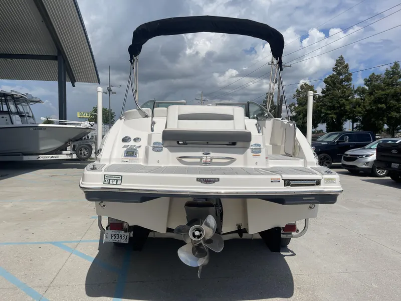 Slide: The Image of 2014 Chaparral Sunesta 224 boat interior with Garmin navigation system, parked in a marina. - 19