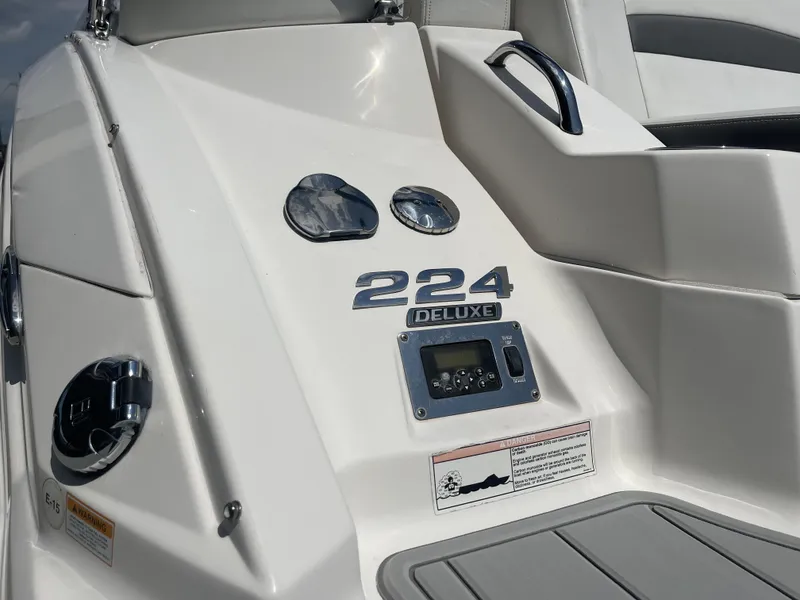 Slide: The Image of 2014 Chaparral Sunesta 224 boat with ladder and propeller, parked outdoors. - 22
