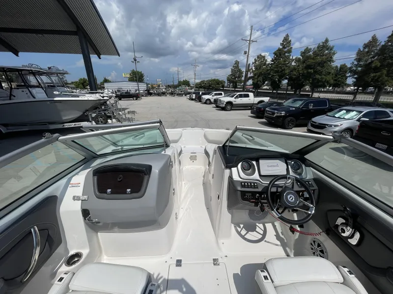Slide: The Image of 2014 Chaparral Sunesta 224 boat interior with white seating and open windshield. - 24