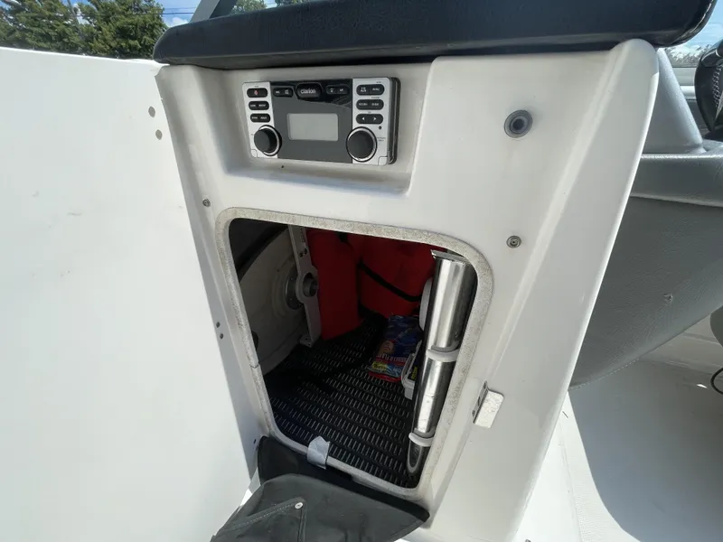 Slide: The Image of 2014 Chaparral Sunesta 224 boat interior with white seating and dashboard. - 30