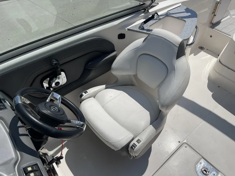 Slide: The Image of 2014 Chaparral Sunesta 224 boat interior with white seating and speaker. - 9
