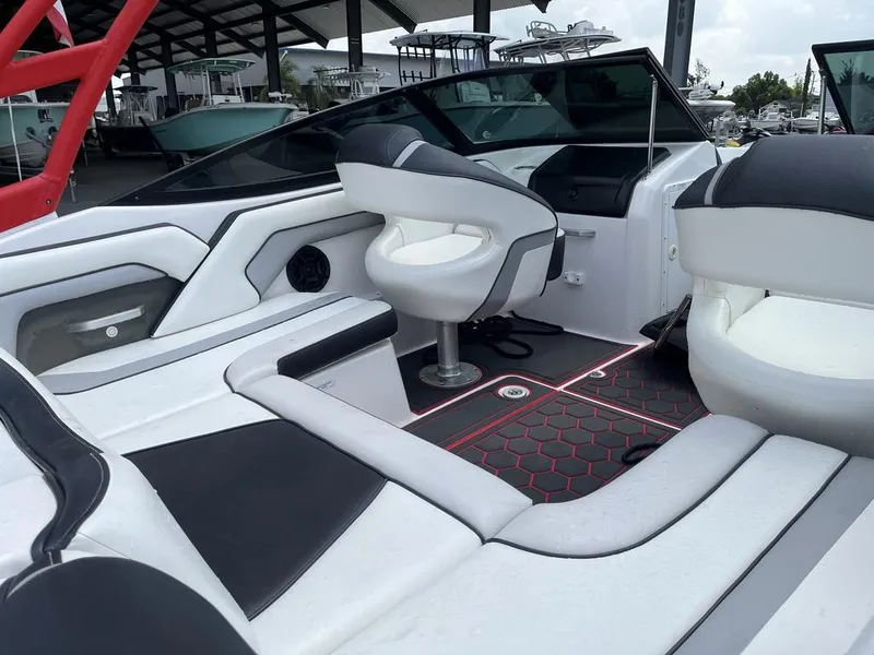Slide: The Image of 2018 Yamaha Boats AR195 interior with white and black seating and dashboard. - 11