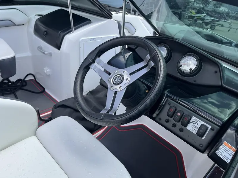 Slide: The Image of 2018 Yamaha AR195 boat interior with steering wheel and seating. - 12