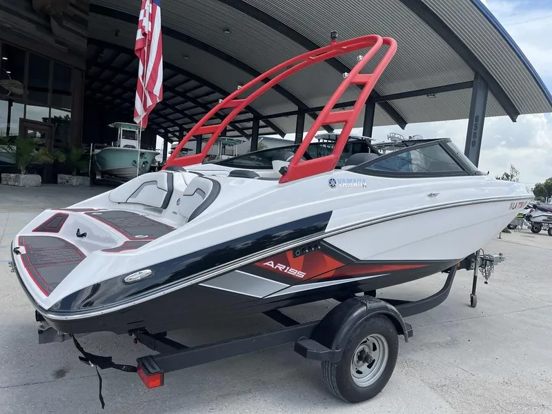 Slide: The Image of 2018 Yamaha AR195 boat on trailer, parked outdoors under a cloudy sky. - 4