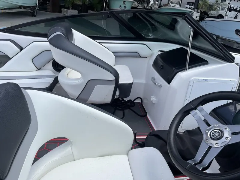 Slide: The Image of 2018 Yamaha AR195 boat on trailer, featuring sleek design and red accents, parked outdoors. - 5