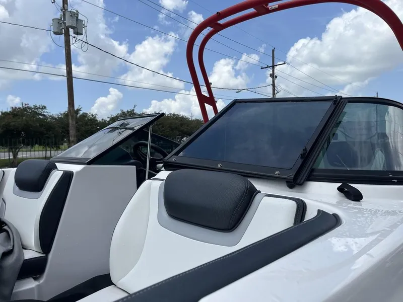 Slide: The Image of 2018 Yamaha Boats AR195, rear view, parked outdoors under cloudy sky. - 6