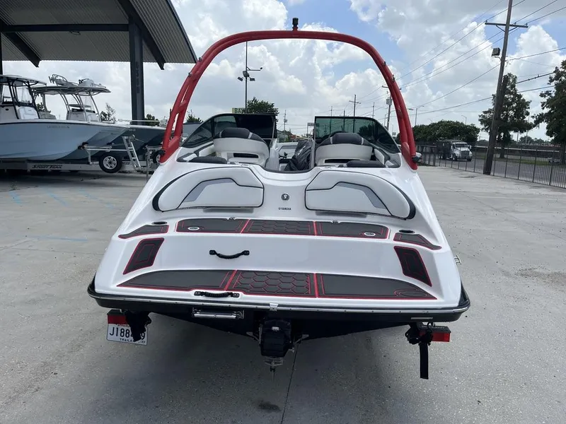 Slide: The Image of 2018 Yamaha Boats AR195 interior with seating and cover, displayed at a showroom. - 8