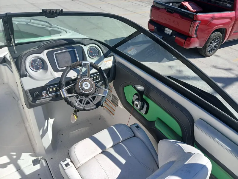 Slide: The Image of Interior of a 2016 Chaparral 203 Vortex boat with steering wheel and dashboard. - 10