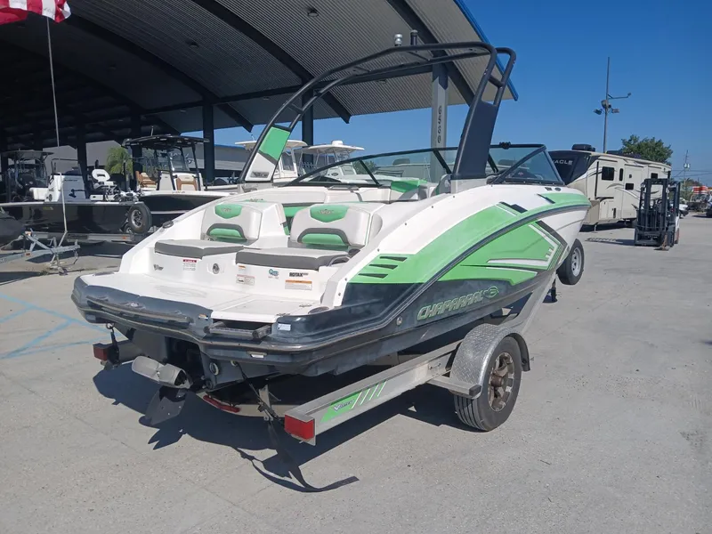 Slide: The Image of 2016 Chaparral 203 Vortex boat with green accents on a trailer in a marina. - 4