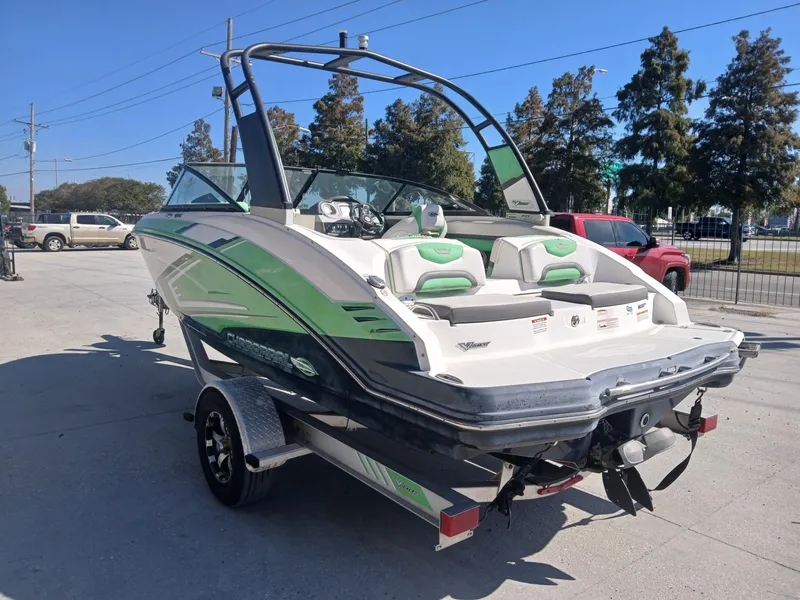 Slide: The Image of 2016 Chaparral 203 Vortex boat on trailer, green and white design, parked outdoors. - 5