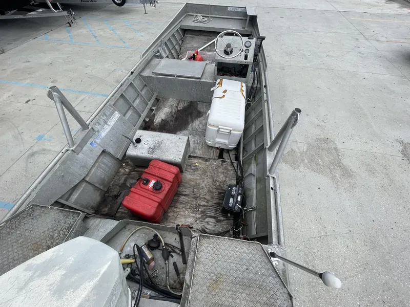 Slide: The Image of 1991 Custom 18ft boat with steering wheel, fuel tank, and cooler on deck. - 11