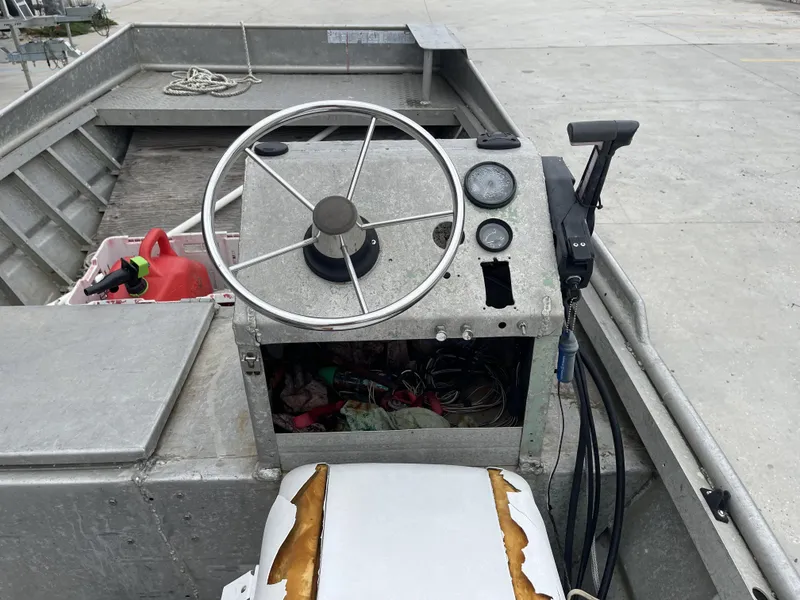 Slide: The Image of Interior of a 1991 Custom 18ft boat with steering wheel and gauges. - 12