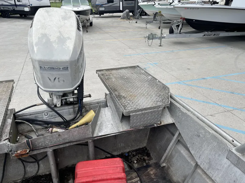 Slide: The Image of Aluminum boat with V6 engine, parked on concrete, Custom 18ft, 1991 model. - 15